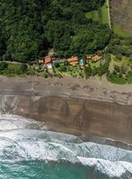 On the beach, black sand, beach towels, beach bar