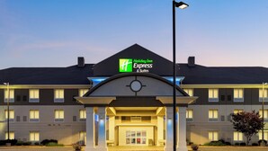 A Holiday Inn Express & Suites building with a prominent entrance, large windows, and a well-lit facade. - Holiday Inn Express Hotel & Suites NORTH FREMONT by IHG (Fremont)