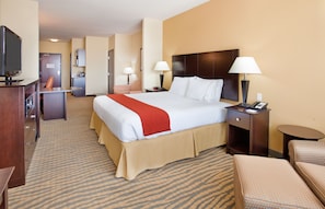 A hotel room with a large bed, bedside tables, a TV, a desk, and a chair. - Holiday Inn Express Hotel & Suites Gallup East by IHG (Gallup)