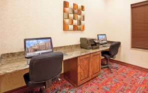 A hotel room with a desk, two chairs, a printer, and a laptop. - Holiday Inn Express Hotel & Suites Gallup East by IHG (Gallup)