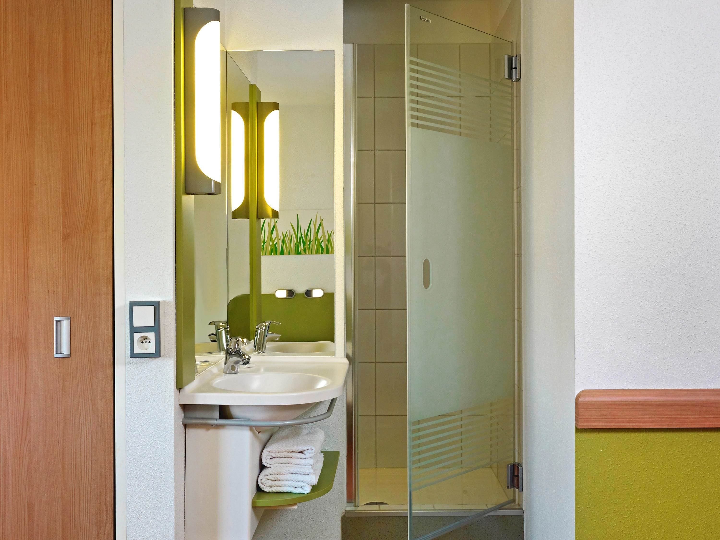 premium room, 1 king bed | bathroom | shower, eco-friendly toiletries, hair dryer, towels