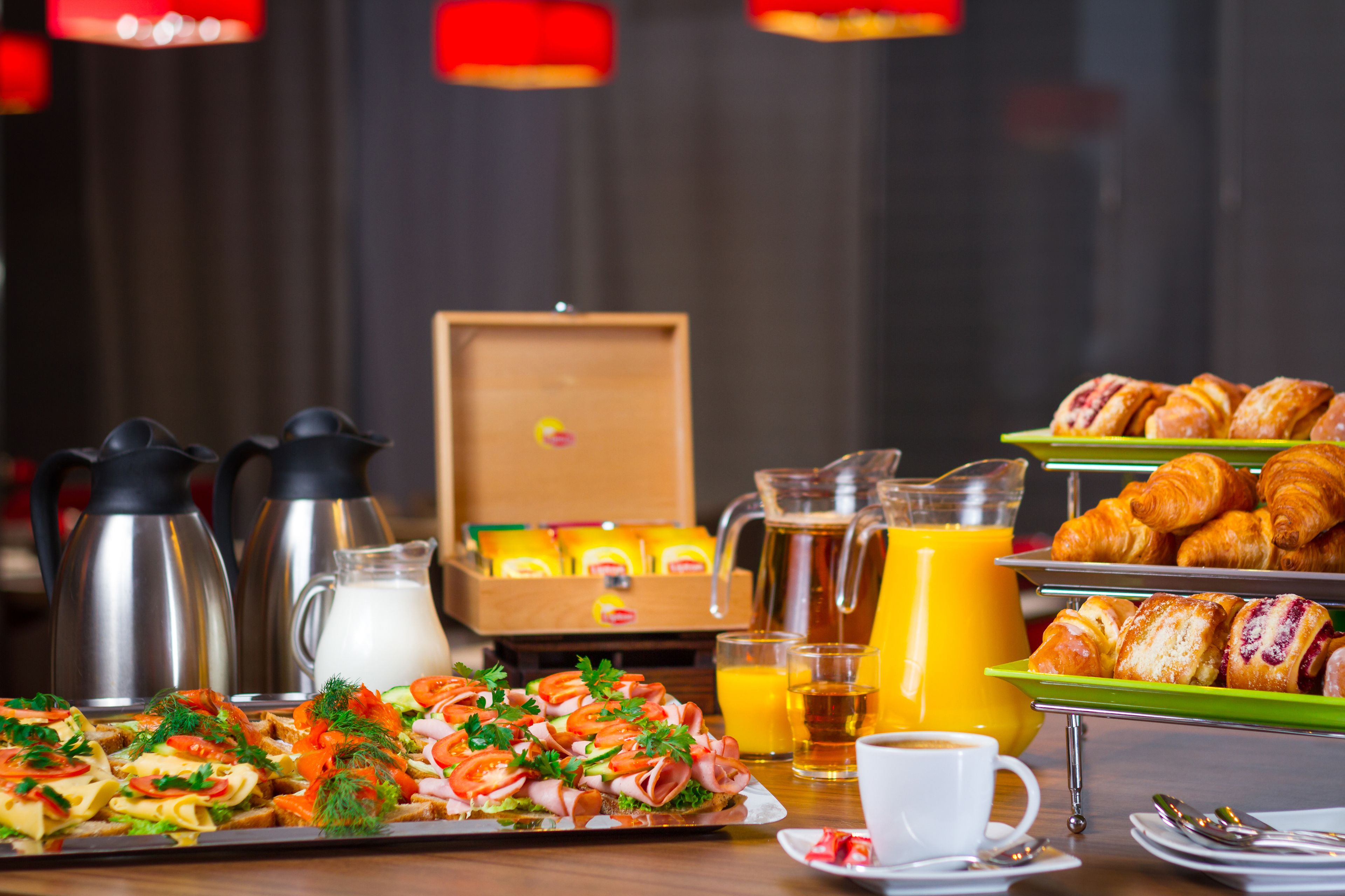 Un buffet della colazione con croissant, dolci e una selezione di panini.