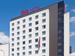 A hotel building with a sign reading 'ibis HOTEL' and multiple windows. - ibis Warszawa West Station (Warsaw)