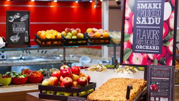 A display of fresh fruits and pastries in a bakery section.