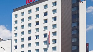 A modern hotel building with a prominent "ibis HOTEL" sign on the top. - ibis Warszawa West Station (Warsaw)