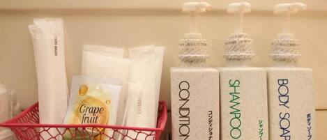 A shelf with various toiletries including a basket with a 'Grape fruit' item, and bottles labeled 'CONDITIONER' and 'SHAMPOO'.