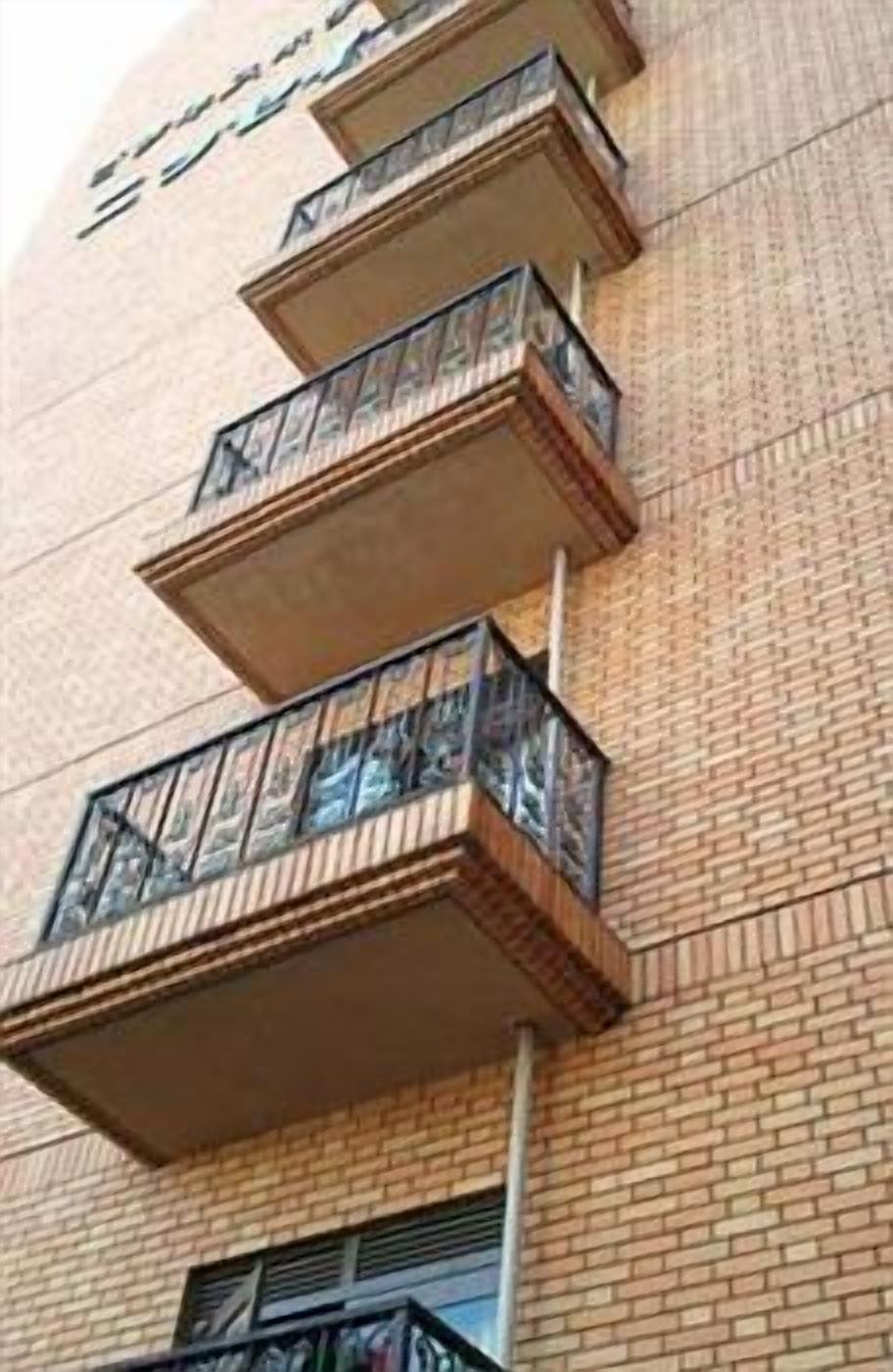 A multi-story building with balconies on each floor.