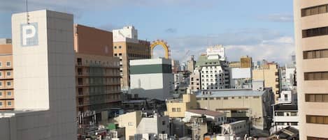 A cityscape with a prominent building featuring a large 'P' sign, indicating a parking facility.