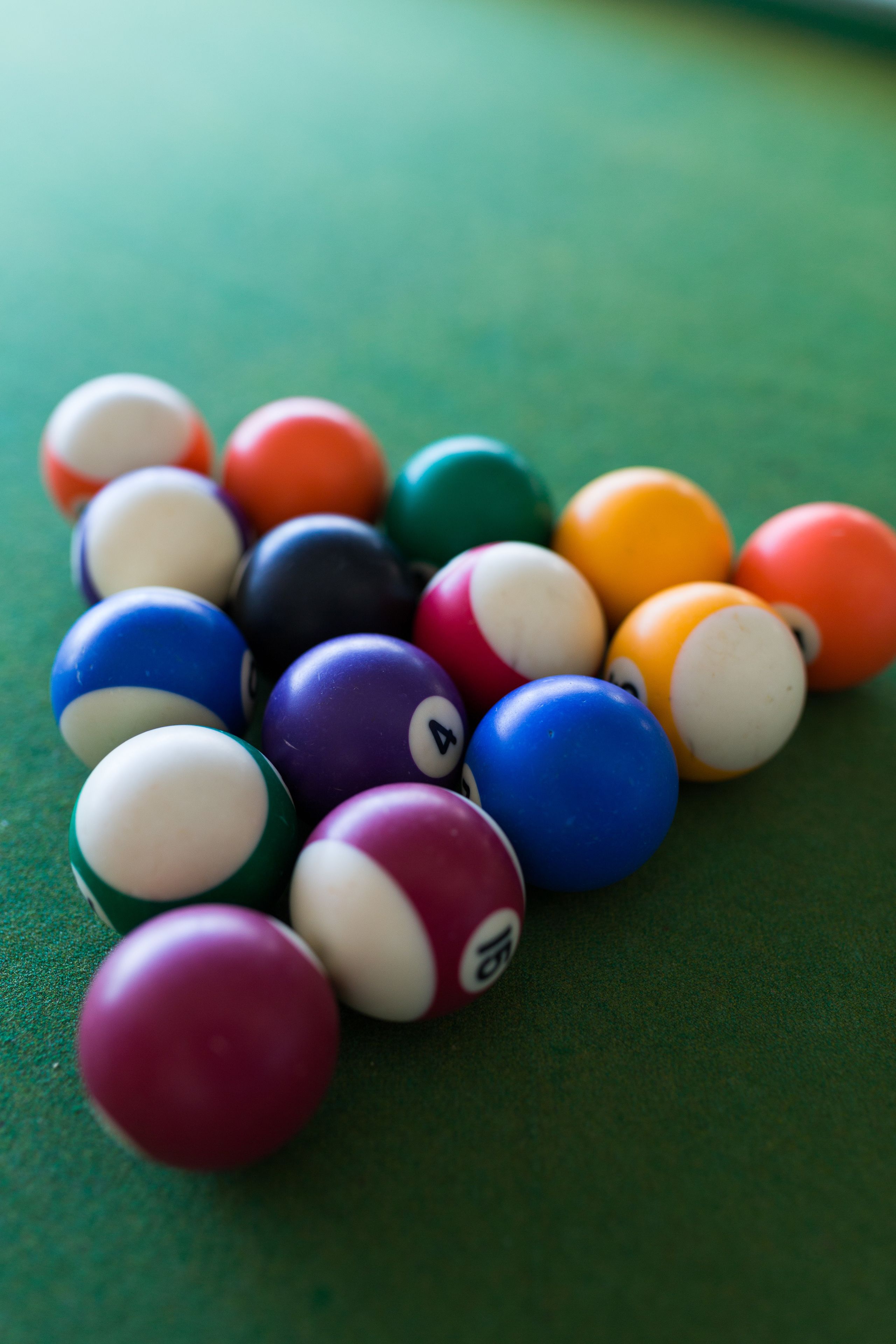 A close-up of a pool table with various colored billiard balls.