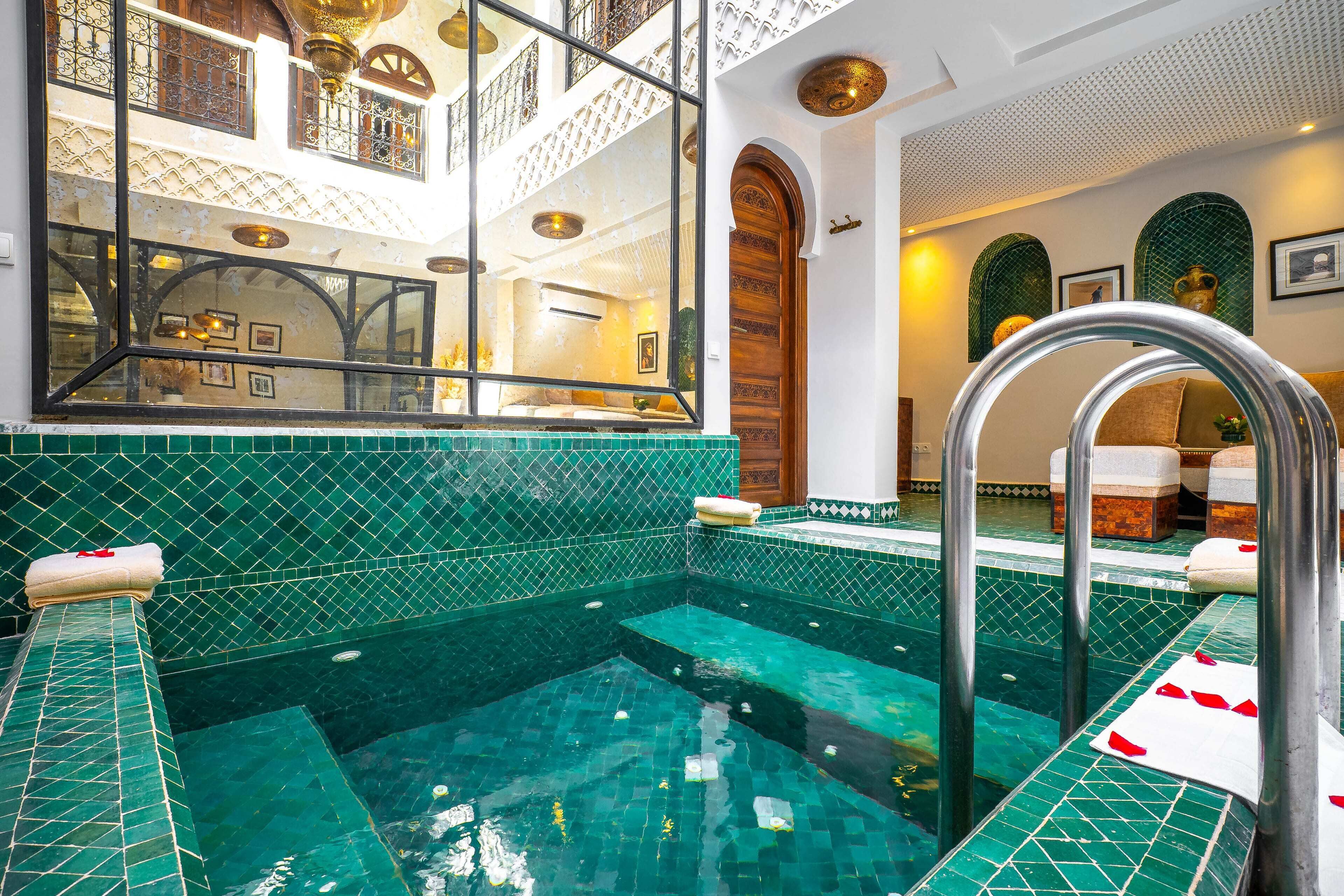 A hotel room with a large window, a pool, and a staircase.