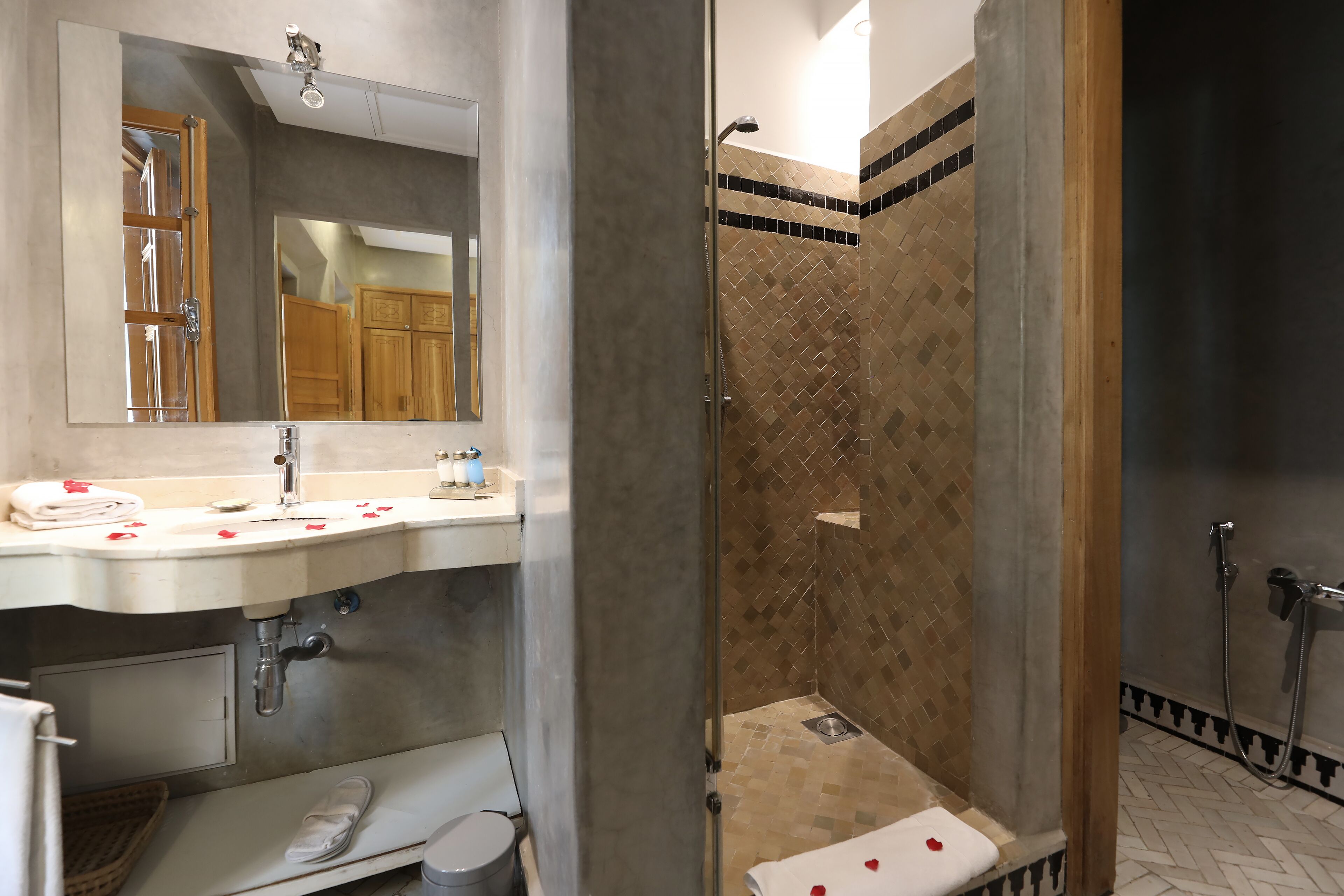 Une salle de bain équipée d’un lavabo, d’un miroir et d’une zone douche.