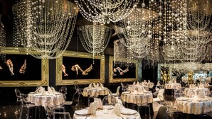 A restaurant with multiple round tables set with white tablecloths, clear chairs, and fine china. - Desire Pearl Riviera Maya Resort – All Inclusive, Exclusively for Couples (Puerto Morelos)