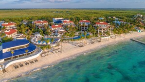 A coastal resort with beachfront villas, a swimming pool, and a pier. - Desire Pearl Riviera Maya Resort – All Inclusive, Exclusively for Couples (Puerto Morelos)