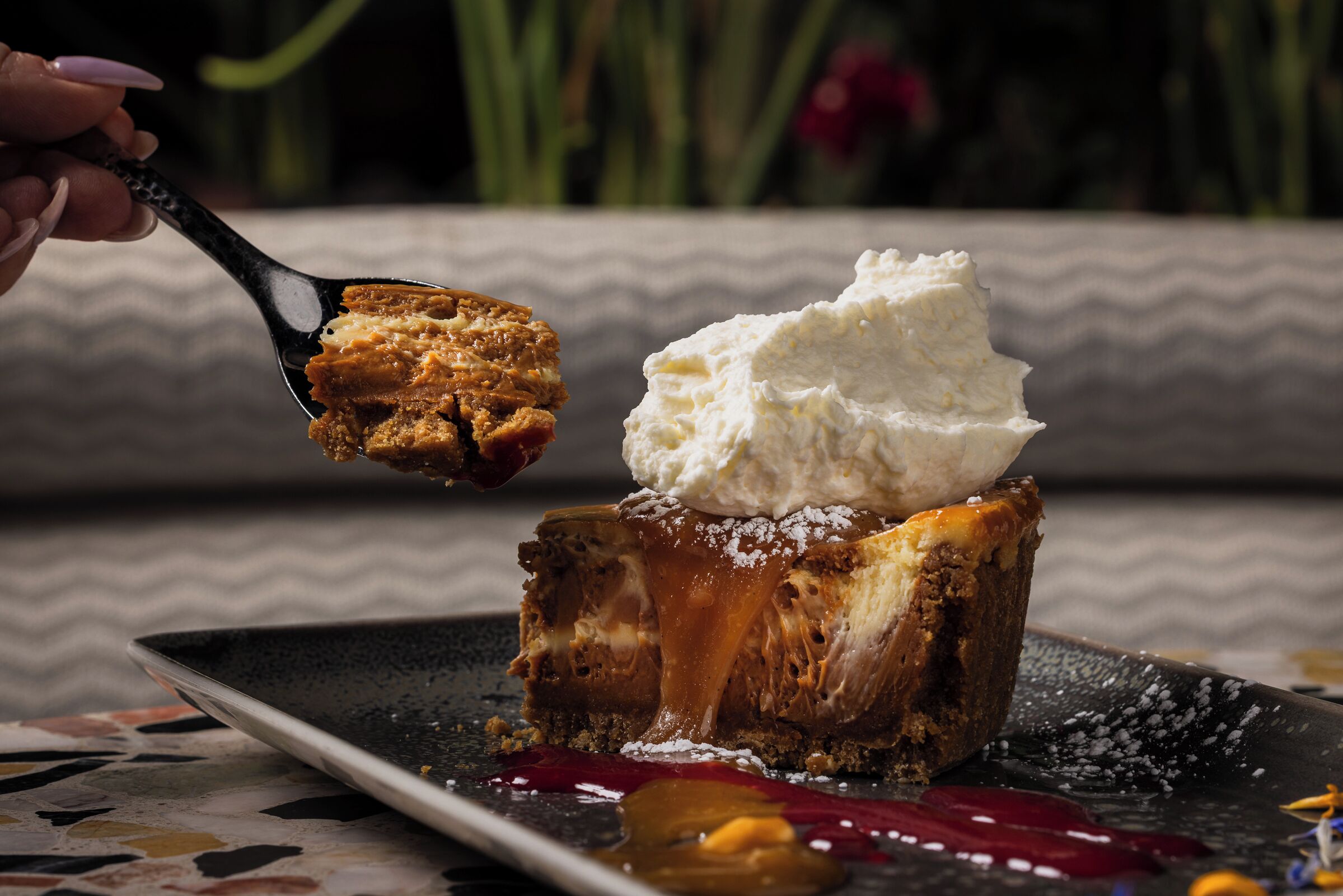 A dessert with caramel and whipped cream on a plate.