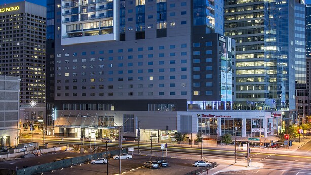 A high-rise hotel with multiple floors, large windows, and a prominent bank sign. - Kimpton Hotel Palomar Phoenix Cityscape by IHG (Phoenix)