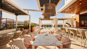 A rooftop bar with a pool view, outdoor seating, and a bar area. - Kimpton Hotel Palomar Phoenix Cityscape by IHG (Phoenix)