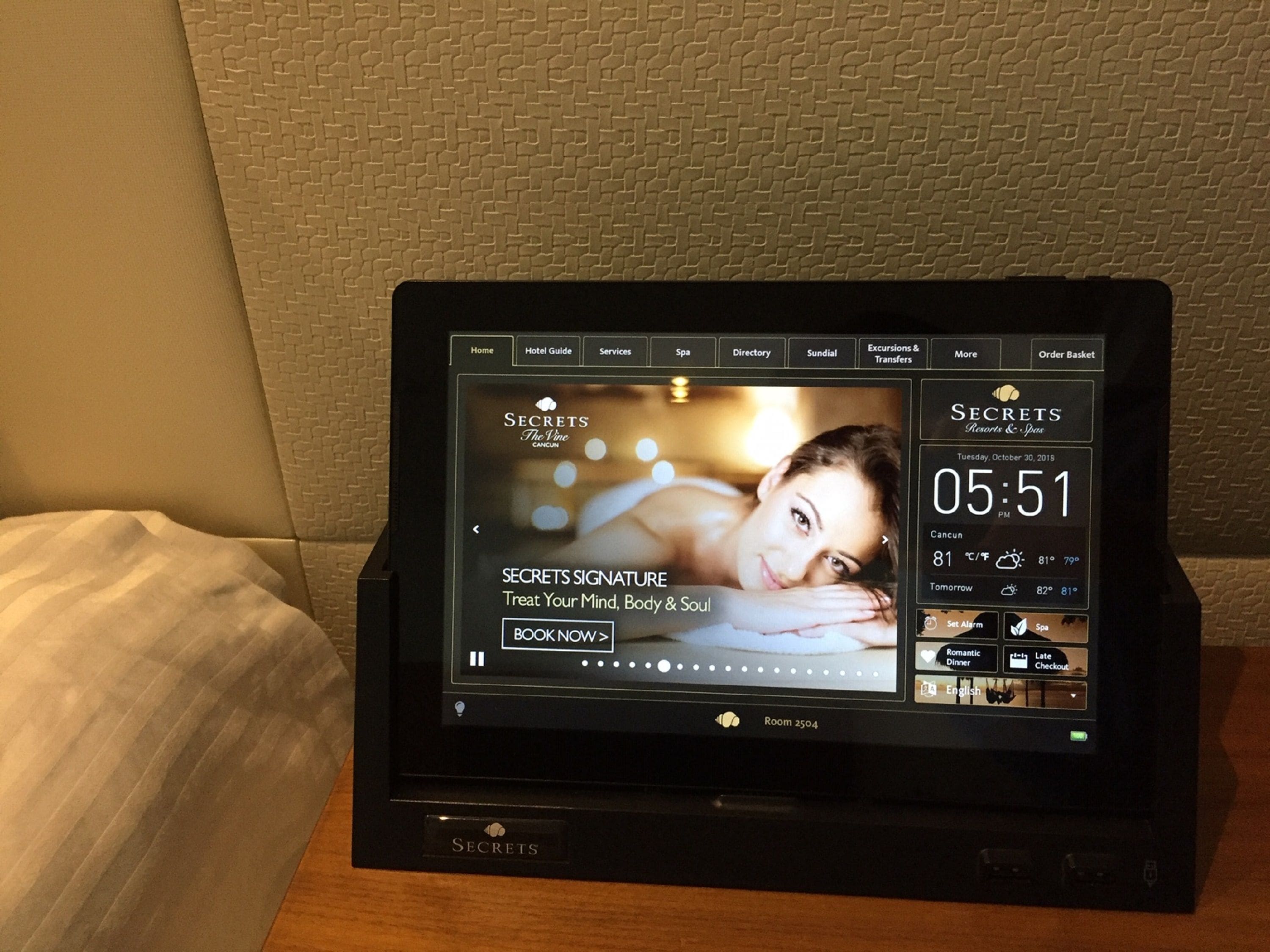 A digital display of a hotel booking interface with options for booking, room details, and a spa section.