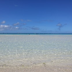 On the beach, white sand, sun loungers, beach umbrellas