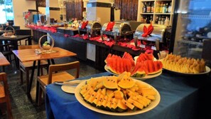 A buffet setup with various food items and a bar area with bottles. - Boracay Ocean Club Resort and Spa (Boracay Island)