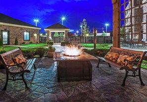An outdoor patio with a fire feature, benches, and a stone pathway. - Staybridge Suites Amarillo - Western Crossing by IHG (Amarillo)