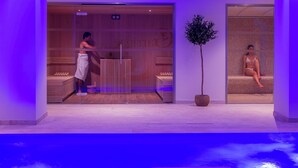 A spa area with wooden paneling, a reception desk, and a seating area with a plant. - Garrigae Domaine de l'Esterel (Saint-Raphael)