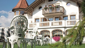 A large, ornate building with multiple balconies, arched windows, and a distinctive tower. - Turmhotel Gschwendt (Valle di Casies)