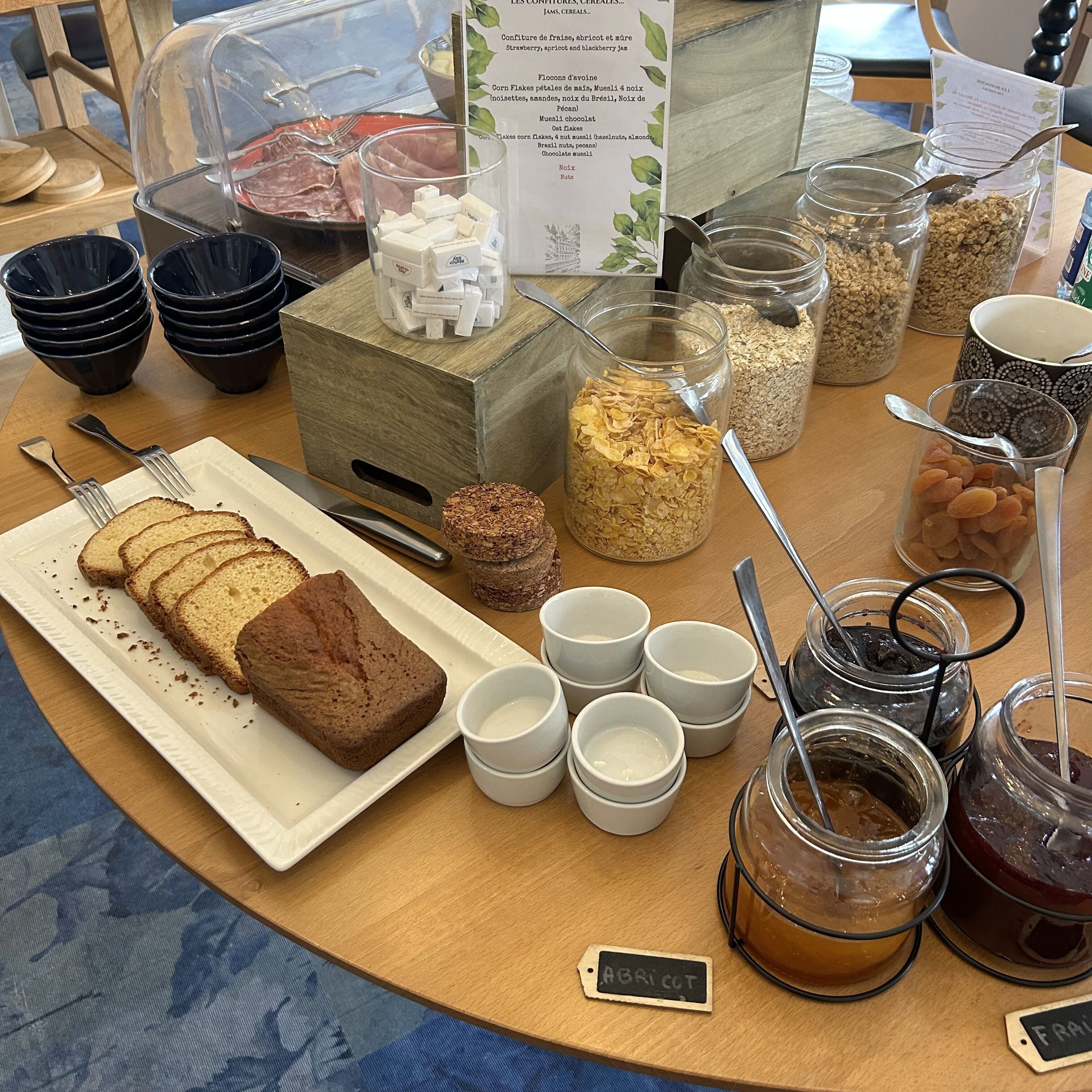 A breakfast buffet with various food items and condiments.