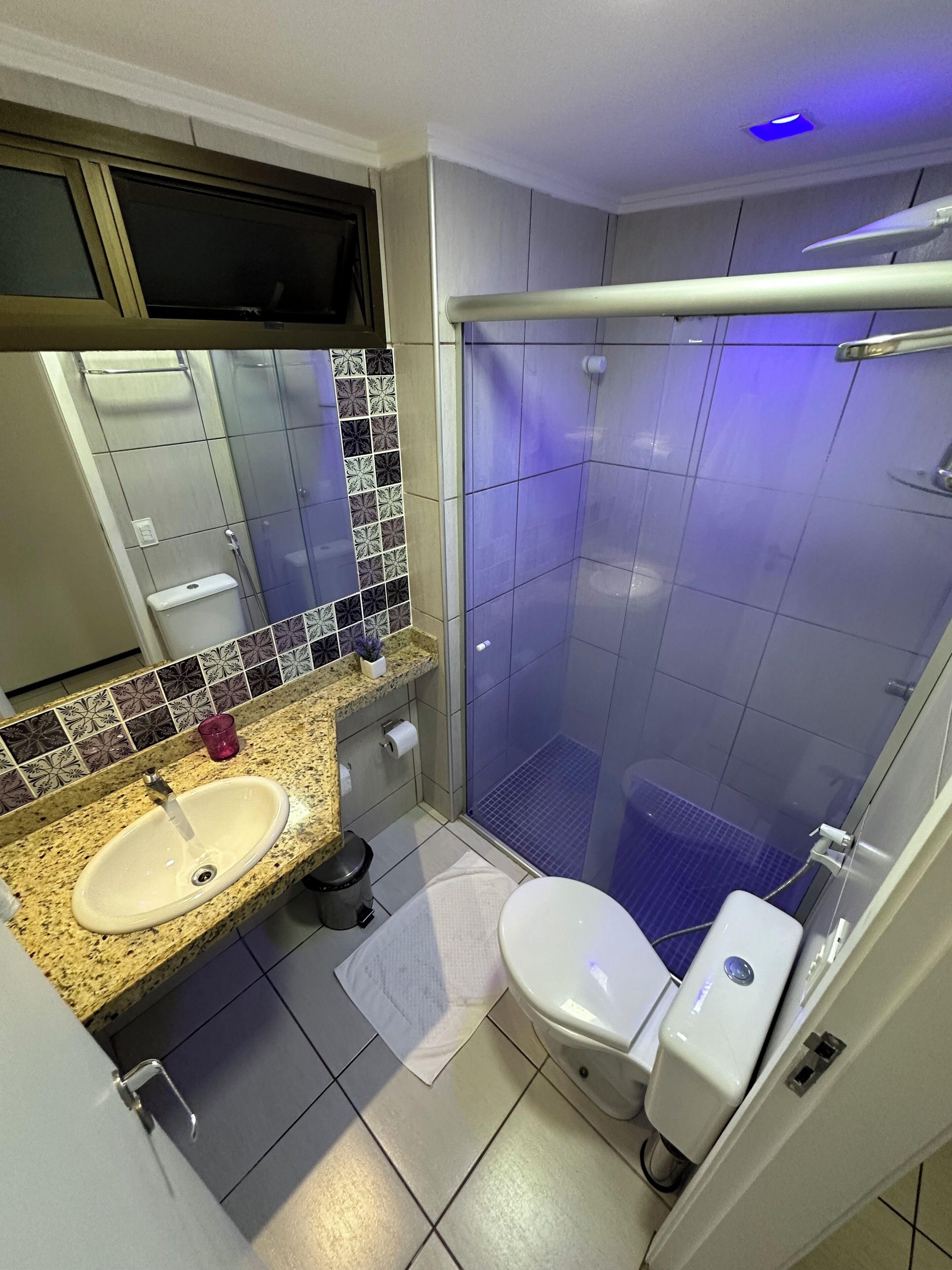 A bathroom with a sink, toilet, and shower.