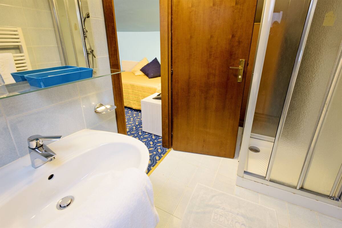 attic twin room with spiral staircase | bathroom | shower, free toiletries, hair dryer, bidet