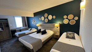 A hotel room with two single beds, a desk, a chair, and a wardrobe. - Brit Hotel Saumur (Distre)