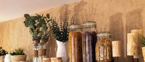 A shelf with jars, a white pitcher, and wooden blocks.