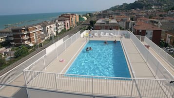 Outdoor pool, open 10:00 AM to 6:00 PM, pool loungers