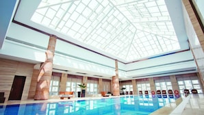 An indoor swimming pool with a high ceiling and large windows. - Tianjin Goldin Metropolitan Polo Club (Tianjin)