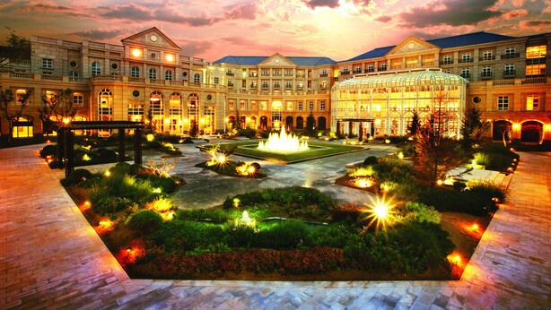 A large, historic building with a central courtyard featuring a fountain, surrounded by well-lit gardens and pathways. - Tianjin Goldin Metropolitan Polo Club (Tianjin)