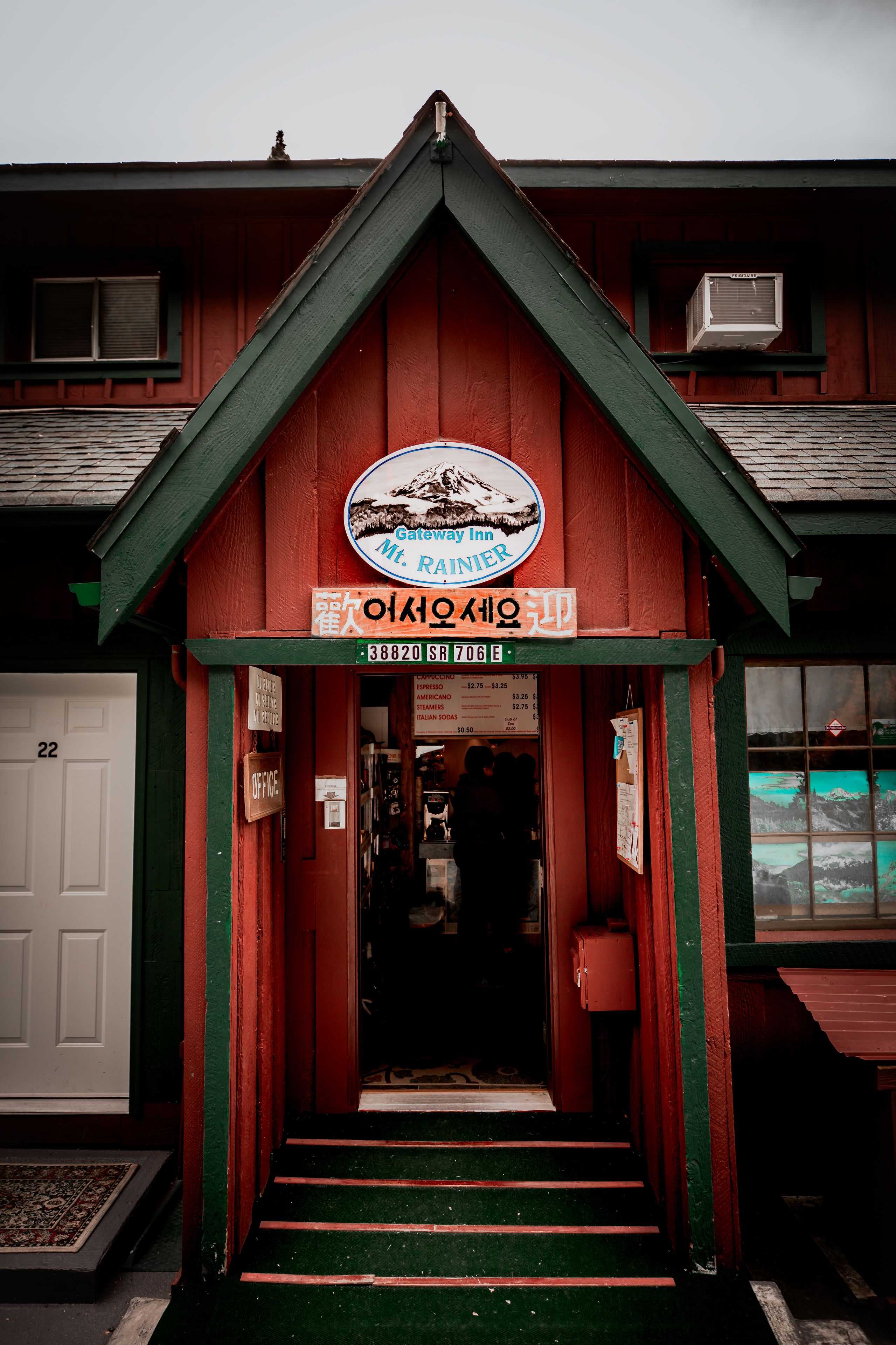 A red building with a sign for the Gateway Inn.
