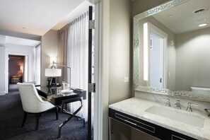 Enjoy a comfortable stay in this stylish room featuring a desk, chair, and large mirror.
