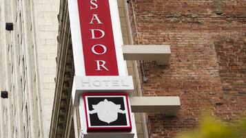 A hotel sign with the name "AMBASSADOR HOTEL" and a symbol indicating a hotel.