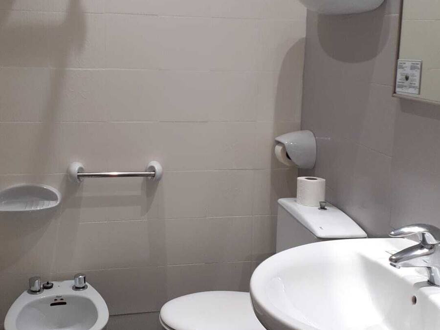 Een badkamer met een toilet, wastafel en een bidet.