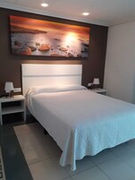 Habitación cuáddruple con terraza, 4 personas | Minibar, caja fuerte, mobiliario individual y escritorio