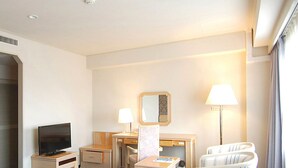 A hotel room with a bed, a desk, a chair, a television, and a lamp. - Hotel Excel Okayama (Okayama)