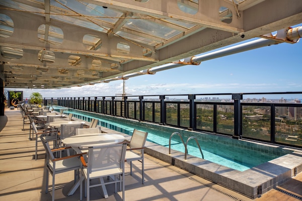 Utomhuspool, parasoller och solstolar