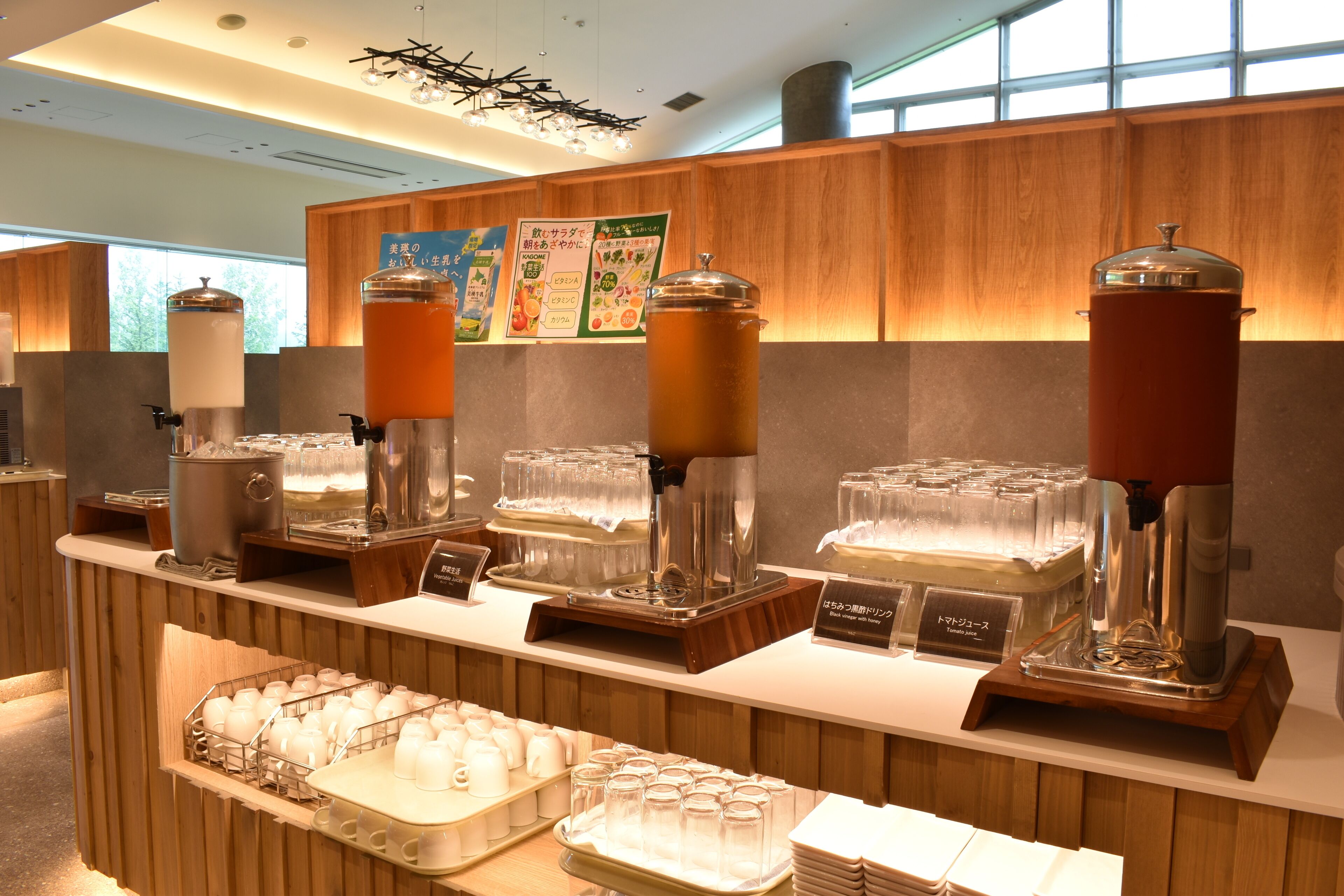 A buffet area with various food and drink dispensers, including a coffee machine and a tea station.