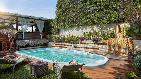 Una piscina al aire libre, tumbonas