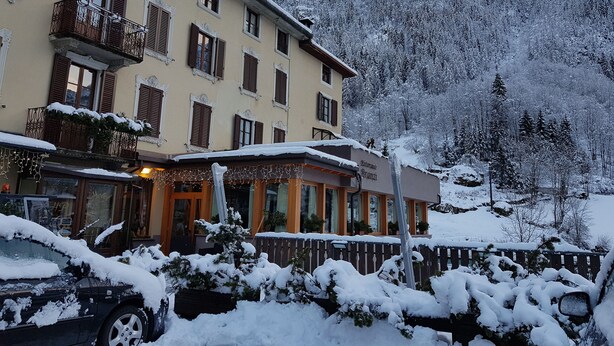 A hotel with a balcony, a sign reading "Ristorante Branzi," and a snowy mountain backdrop. - Hotel Pedretti (Branzi)