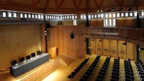 A large hall with a high wooden ceiling and a central stage. Rows of chairs are arranged for seating. - Canterbury Cathedral Lodge (Canterbury)