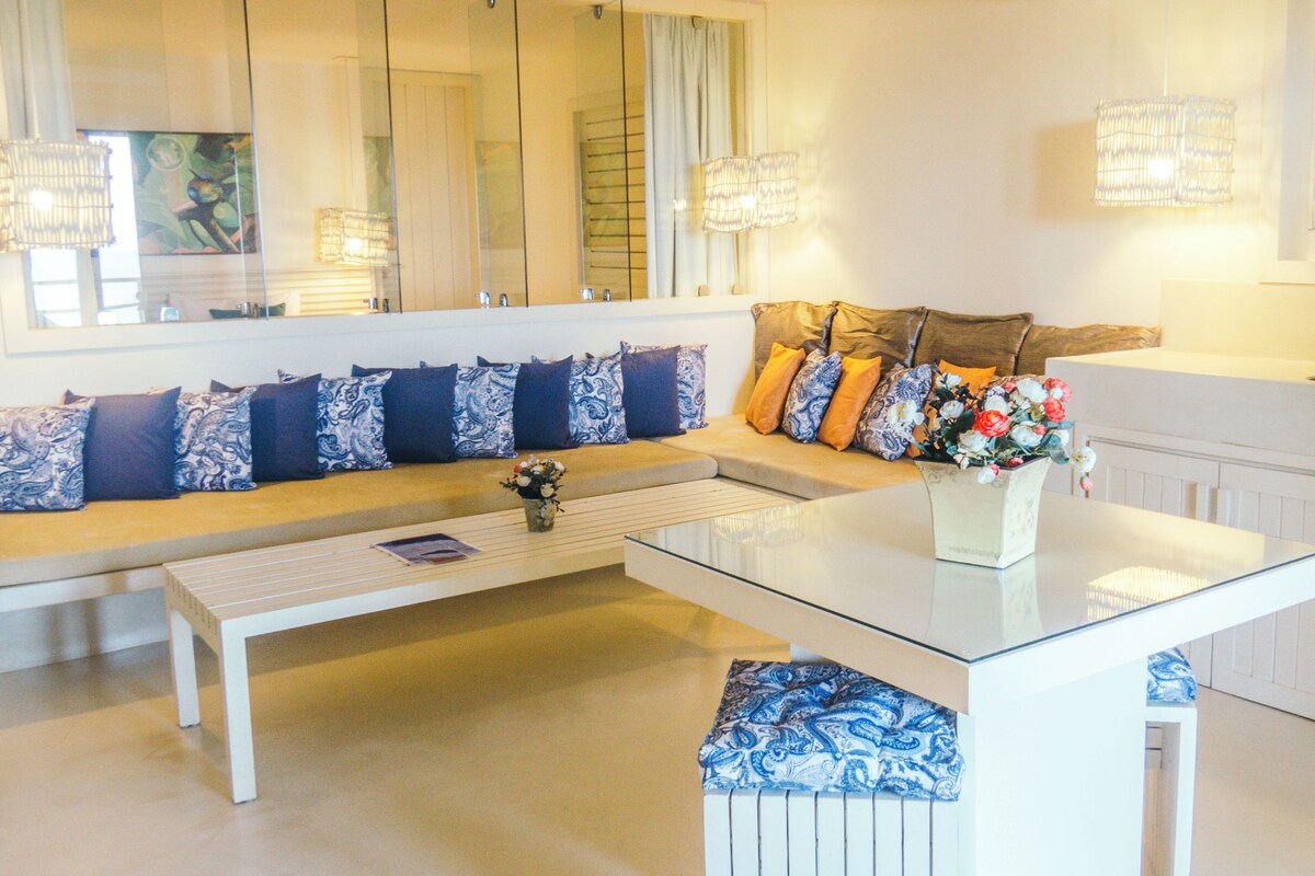 A modern living room with a sofa, coffee table, and decorative pillows.