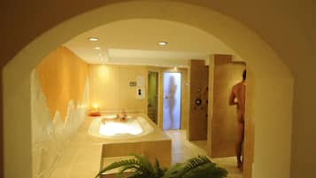 Bathroom features a bathtub and a large mirror.