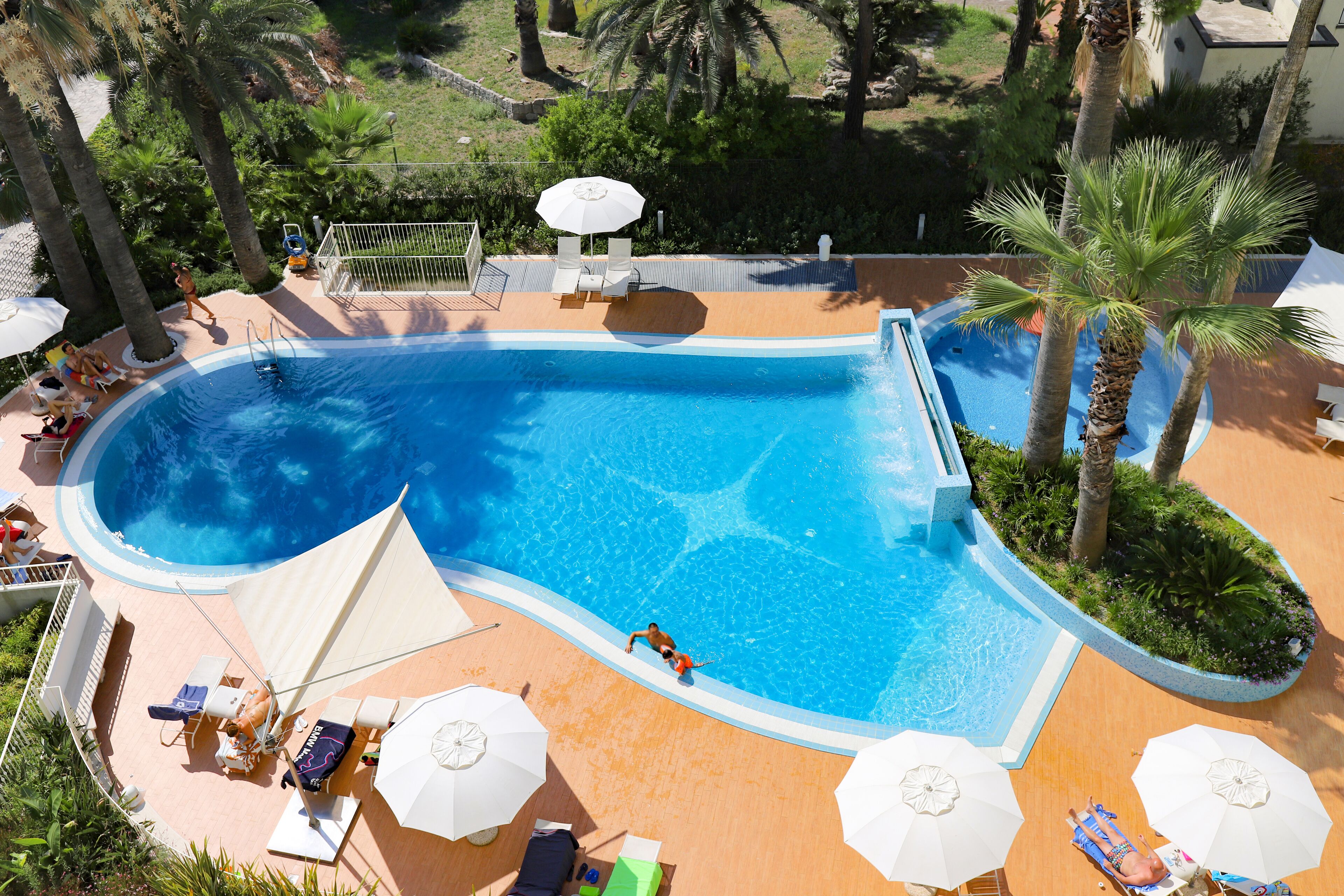 Seasonal outdoor pool, open 10:00 AM to 7:00 PM, pool umbrellas