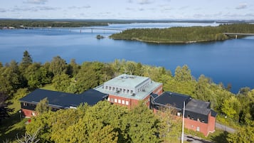 Situated near a serene lake, this property offers a tranquil retreat surrounded by lush greenery and dense trees.