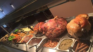 A buffet with various dishes including roasted meats and side dishes. - Royal Hotel (Norwich)